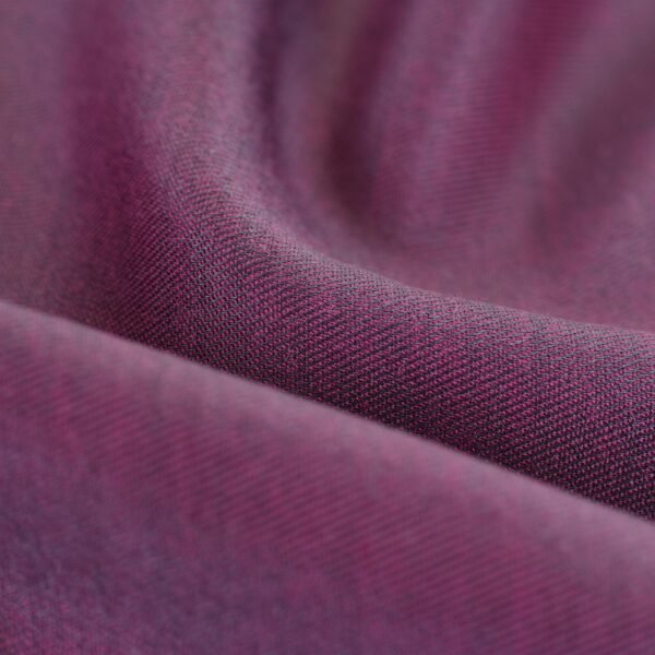Detailed close-up of purple fabric showcasing its rich texture and softness.