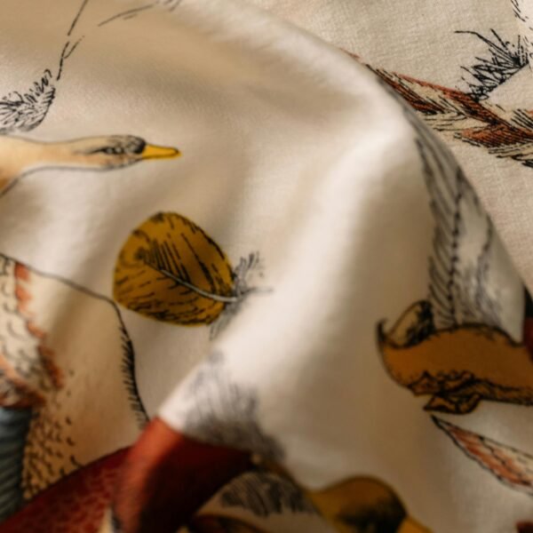 Detailed bird illustrations on draped fabric, showcasing vintage art style.